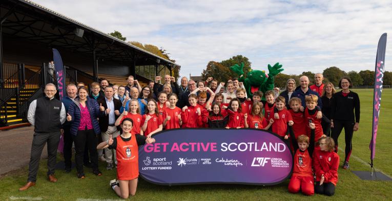 A group photo of funders, stakeholders, Olympian Megan Keith and primary school pupils at the launch of Get Active Scotland in Bught Park, Inverness
