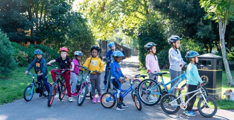 Group of children on bikes in a park 