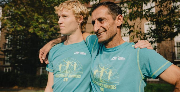 Two Sanctuary Runners smiling with their arms round each others shoulders