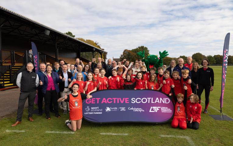 A group photo of funders, stakeholders, Olympian Megan Keith and primary school pupils at the launch of Get Active Scotland in Bught Park, Inverness