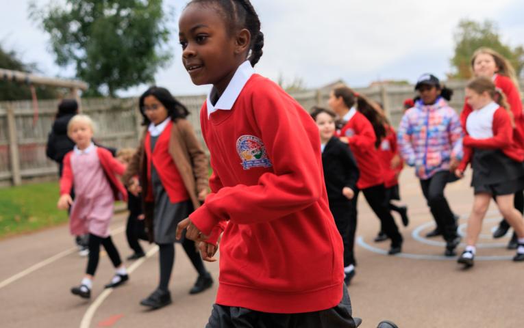 Pupils taking part in The Daily Mile in a school playground 