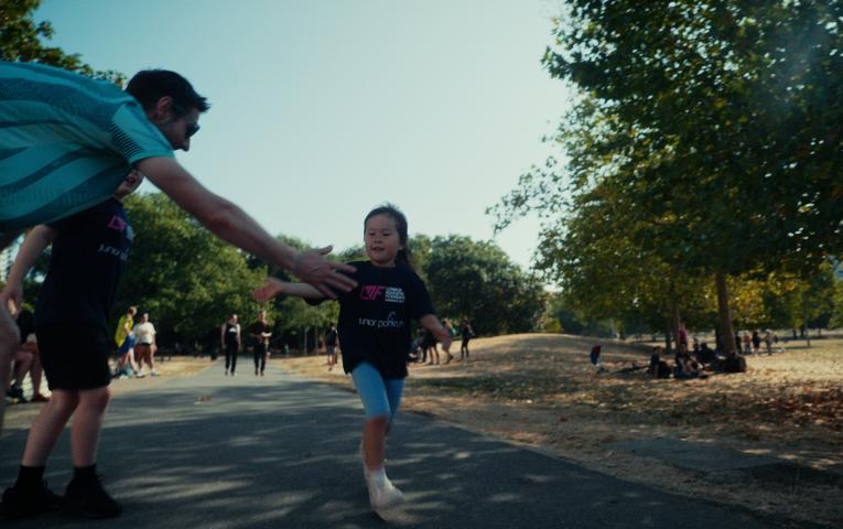 child hi fives parent at junior parkrun