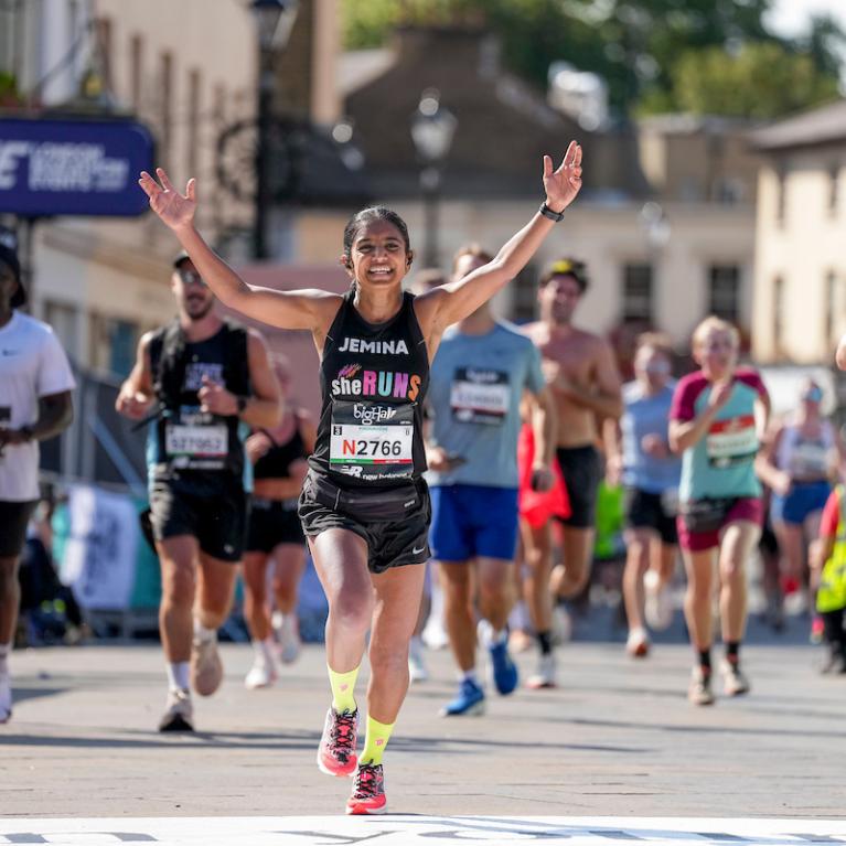Runner crossing the Big Half Finish Line