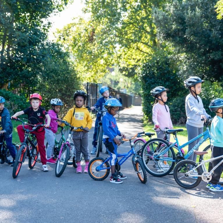 Group of children on bikes in a park 