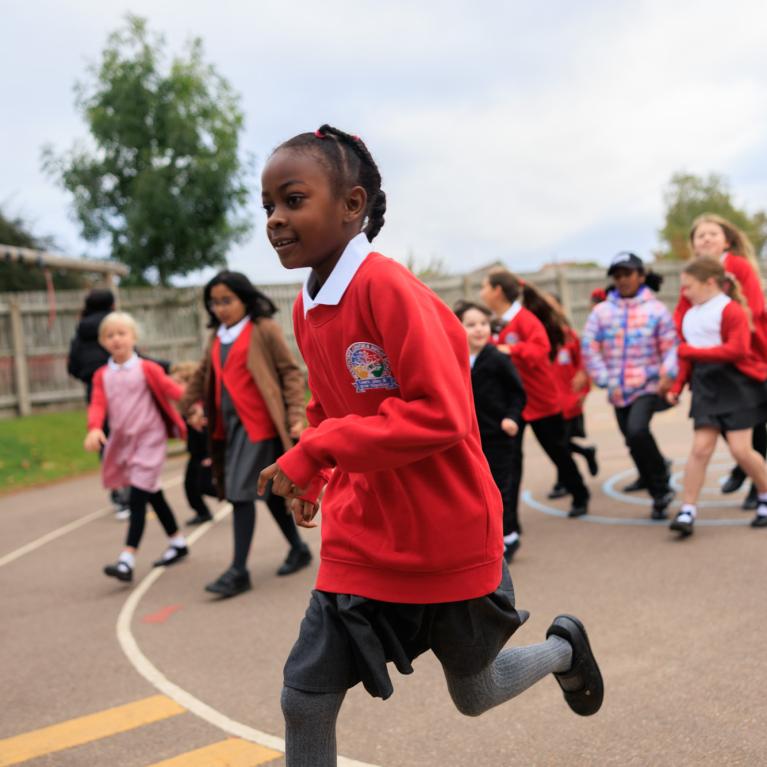 Pupils taking part in The Daily Mile in a school playground 