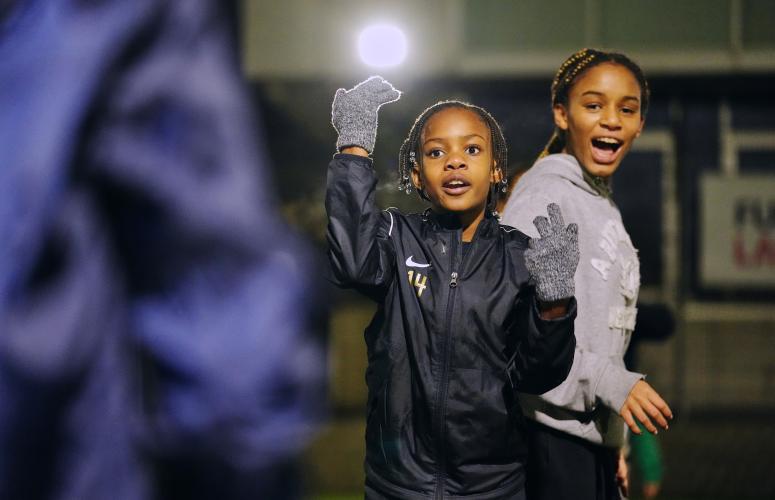 Girls playing football outside