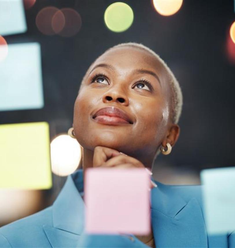 Woman looking over post it notes