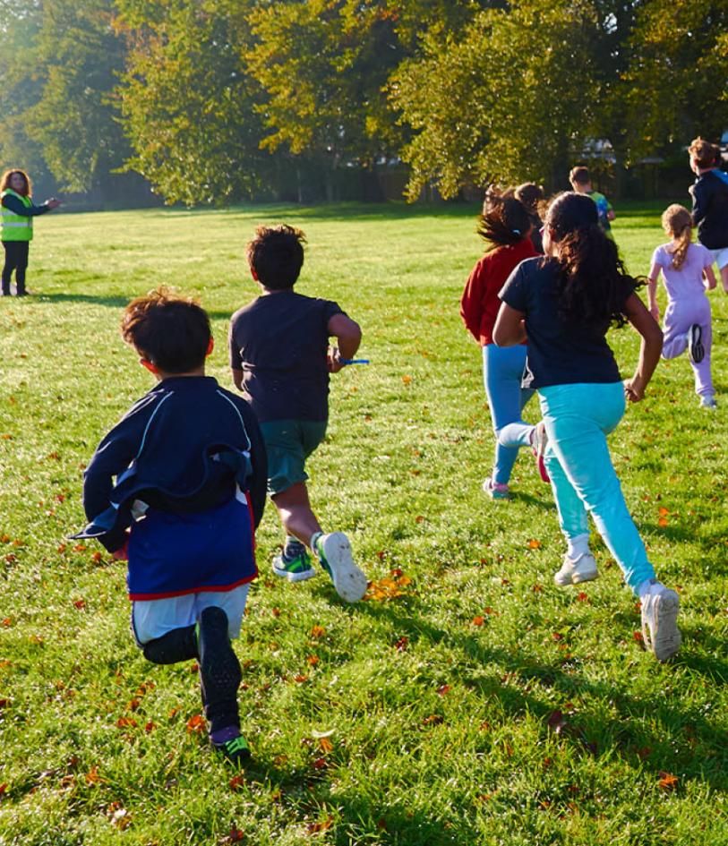 Children running into the sunshine during junior parkrun