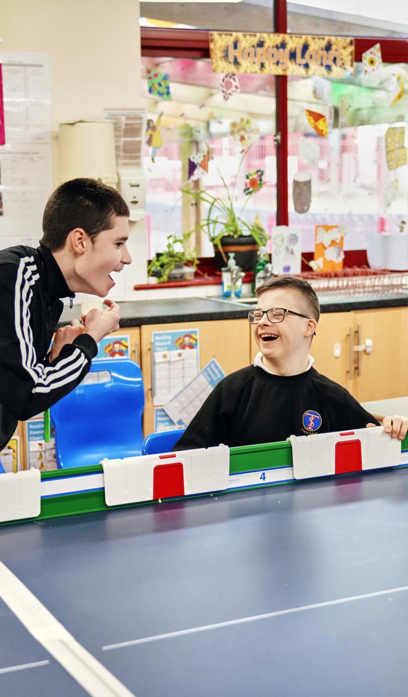 Two boys celebrating winning a game