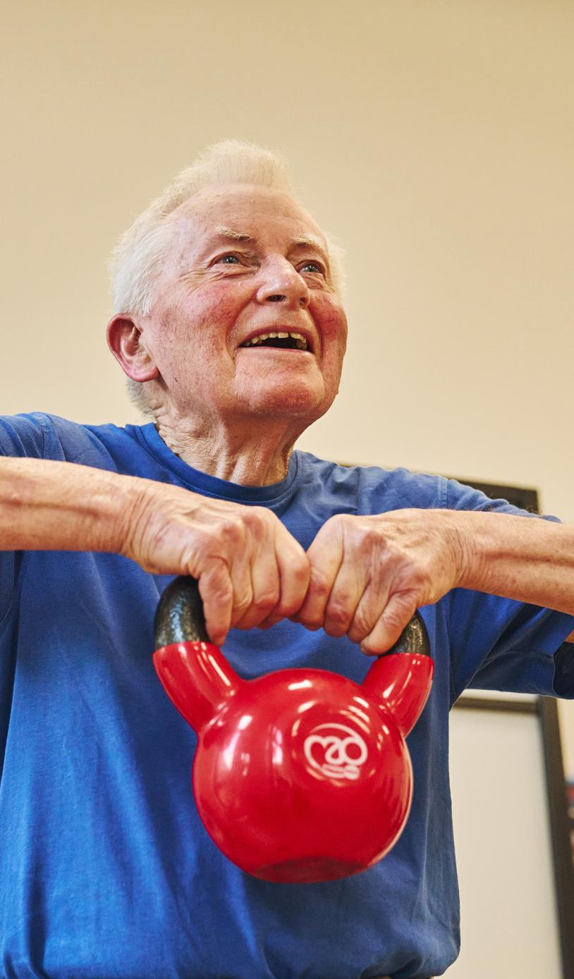 An older man lifting a kettlebell