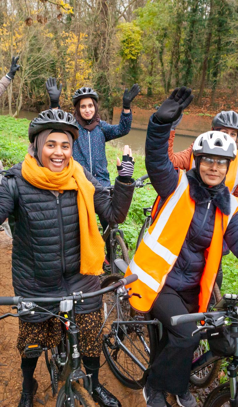A group of women on bikes on a tow path 